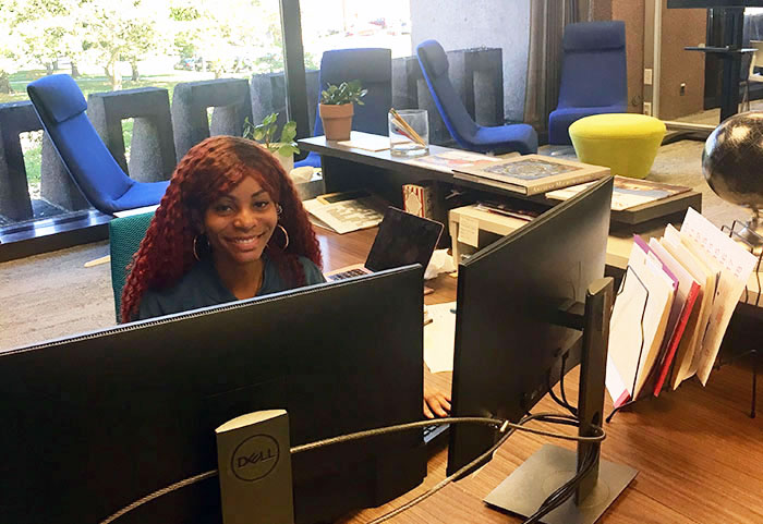 SOURCE staff member at desk working on computer